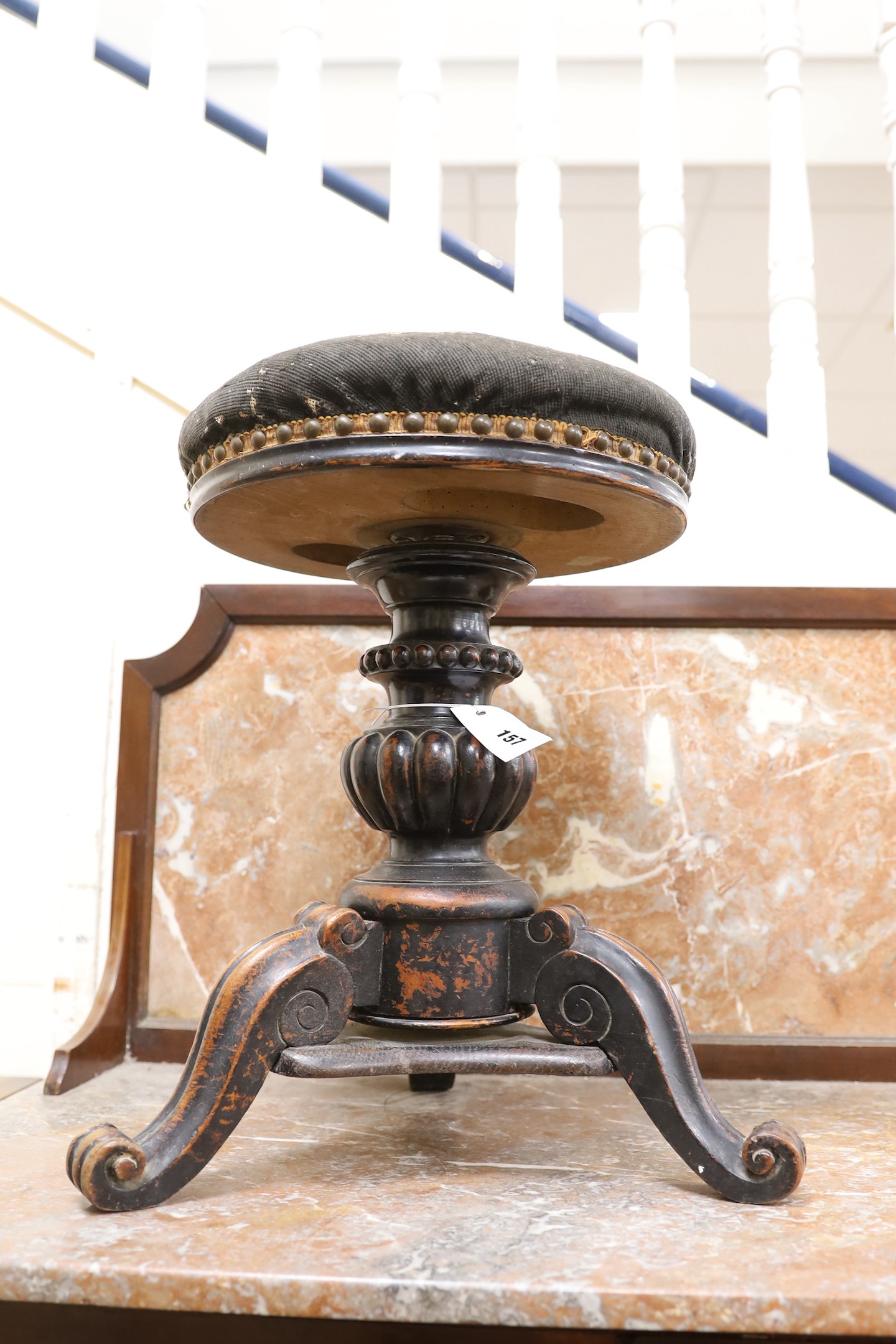 A Victorian mahogany adjustable revolving piano stool with tapestry seat